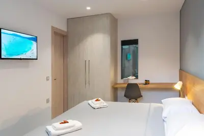 a bedroom with a bed with two towels on it at Casa Del Mare Luxury Guest House in Chania Town