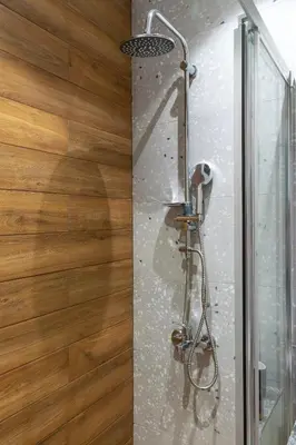 a shower in a bathroom with a wooden wall at Casa Del Mare Luxury Guest House in Chania Town