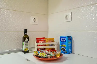 a bottle of wine and a bowl of food on a counter at Souda apartment in Souda