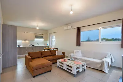 a living room with a couch and a table at Souda apartment in Souda