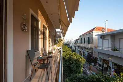 a balcony of a building with chairs on it at Calliope Rooms 1 in Kissamos