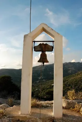 a bell on top of a hill with a view at Christos Place-Anidri in Palaiochóra