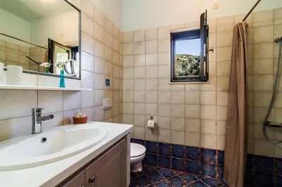 a bathroom with a sink and a toilet at Christos Place-Anidri in Palaiochóra