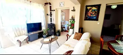 a living room with a couch and a tv at Kedrodasos House in Elafonisi