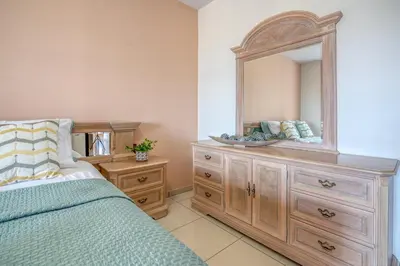 a bedroom with a wooden dresser and a mirror at Michael's Villa in Kissamos