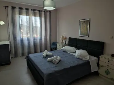 a bedroom with a bed with two towels on it at Villa Lakki's Ori in Lákkoi