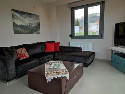 a living room with a couch and a coffee table at Villa Lakki's Ori in Lákkoi