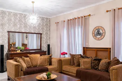 a living room with two couches and a piano at Laurel Heights Apartment in Chania Town