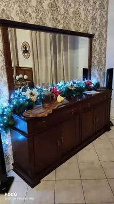 a dresser with a mirror and blue lights on it at Laurel Heights Apartment in Chania Town