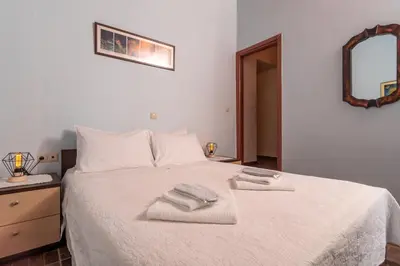 a bedroom with a white bed with towels on it at Villa Araxovoli in Palaiochóra