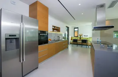 a kitchen with a stainless steel refrigerator and a dining room at Villa Night Flower in Chania Town