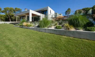 a house with a lawn in front of it at Villa Night Flower in Chania Town