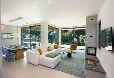 a living room with a white couch and a fireplace at Villa Night Flower in Chania Town