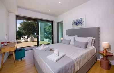 a bedroom with a bed and a desk and a window at Villa Night Flower in Chania Town