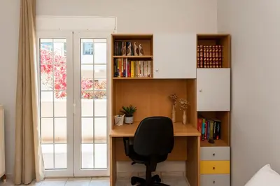 a desk with a chair in a room with a window at Aura Estate in Chania Town