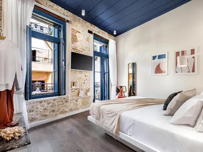 a bedroom with a bed and a window at New Boutique Venetian apartments - La Casa Nove in Chania Town