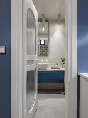 a white bathroom with a sink and a tub at New Boutique Venetian apartments - La Casa Nove in Chania Town