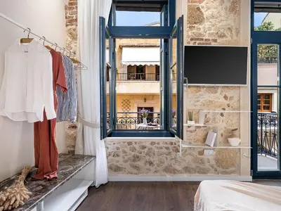 a bedroom with a window and a room with a bed at New Boutique Venetian apartments - La Casa Nove in Chania Town
