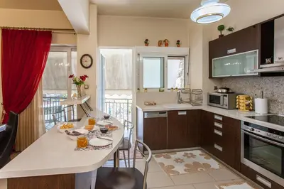 a kitchen with a table with chairs and a counter top at Downtown apartment in Chania in Chania Town
