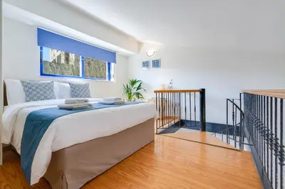 a bedroom with a large bed in a room at Beach House Kalamaki steps away from the beach in Galatás