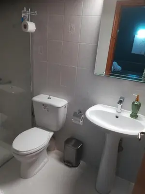 a bathroom with a toilet and a sink at Mari Helen in Kamisianá