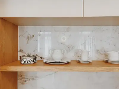 a shelf with cups and saucers on it at Kale Kapi City Living in Chania Town