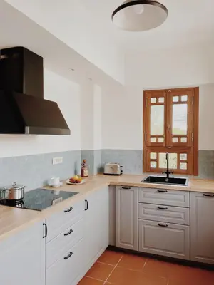 a kitchen with white cabinets and a stove top oven at Kale Kapi City Living in Chania Town