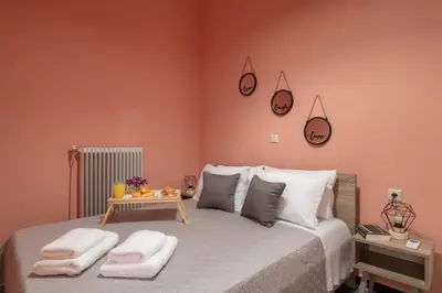 a bedroom with a large bed with two towels on it at Square Apartment in Kambanós