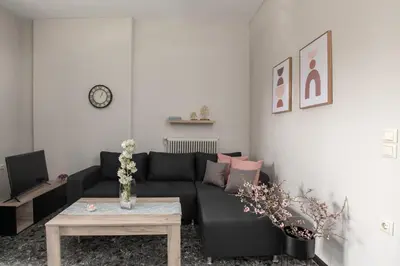 a living room with a black couch and a table at Square Apartment in Kambanós