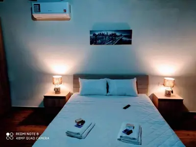 a bedroom with a bed with two nightstands and two lamps at Traditional Villa in Pemonia in Pemónia