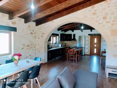 a kitchen and living room with a stone wall at Traditional Villa in Pemonia in Pemónia