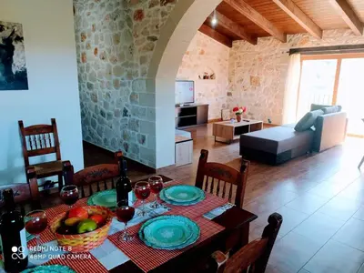 a dining room with a table and a living room at Traditional Villa in Pemonia in Pemónia