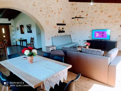 a living room with a couch and a table at Traditional Villa in Pemonia in Pemónia