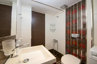 a bathroom with a white toilet and a sink at Erontas Apartment in Palaiochóra