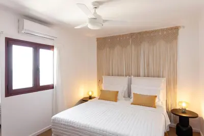 a white bedroom with a white bed and a window at FOS - casa casa group in Chania Town