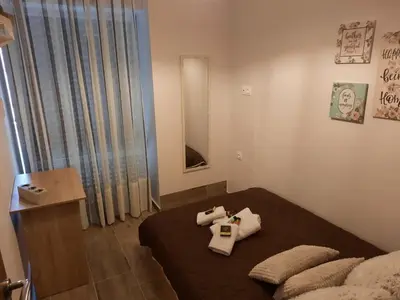 a room with a bed with two pillows on it at SummerSense Apartment in Chania Town