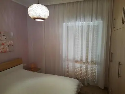 a bedroom with a white bed and a window at SummerSense Apartment in Chania Town