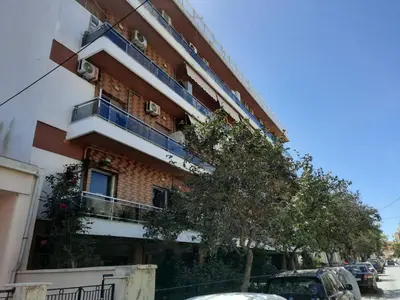 a building with cars parked in front of it at SummerSense Apartment in Chania Town