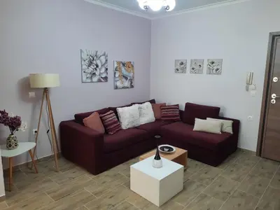 a living room with a couch and a table at SummerSense Apartment in Chania Town
