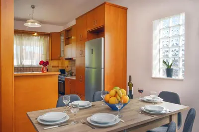 a kitchen with a table with a bowl of fruit on it at Gavalas Urban Home in Chania Town