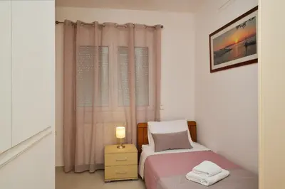 a small bedroom with a bed and a window at Gavalas Urban Home in Chania Town