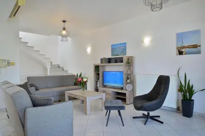 a living room with a couch and chairs and a tv at Gavalas Urban Home in Chania Town