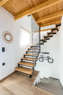 a staircase in a house with a wooden ceiling at Casa Galatas in Galatás