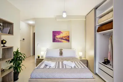 a bedroom with a large bed in a room at Avanti Chania Luxury Apartment in Chania Town