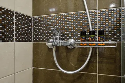 a shower with a hose in a bathroom at Avanti Chania Luxury Apartment in Chania Town