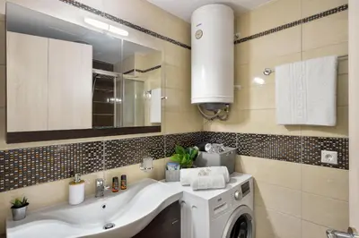 a bathroom with a sink and a washing machine at Avanti Chania Luxury Apartment in Chania Town