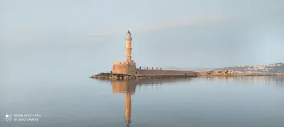 a lighthouse on an island in the middle of a body of water at Avanti Chania Luxury Apartment in Chania Town