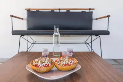 two donuts on a plate on a table with glasses at Villa Cleronomia, private pool, seaview, in Kaloudhianá