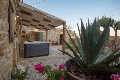 a patio with a pineapple plant in a yard at Pamelas House with Jacuzzi in Kissamos