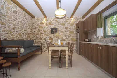 a living room with a couch and a table at Pamelas House with Jacuzzi in Kissamos
